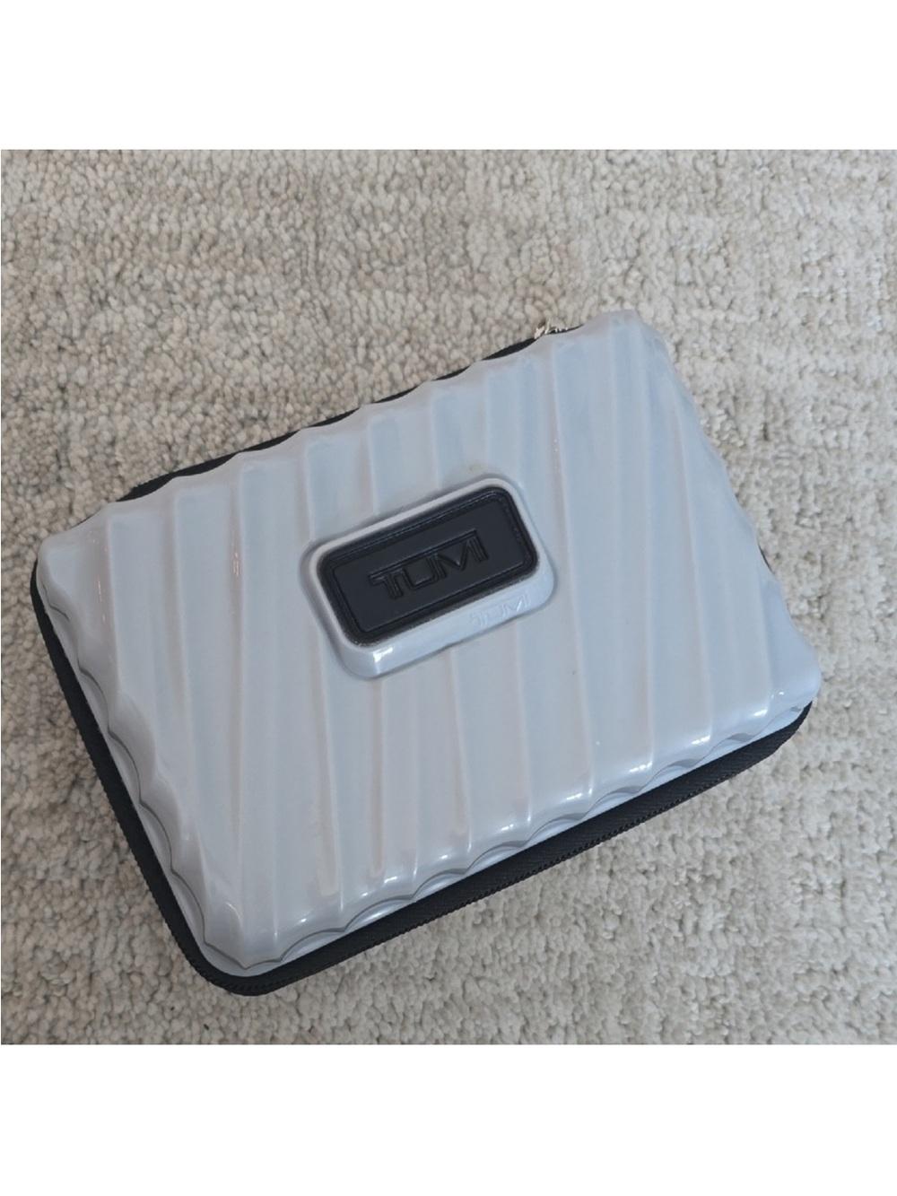 Tumi Glossy White and Black Ridged Hard-Shell Case